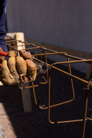 worker assembling metal beams for filling with cement