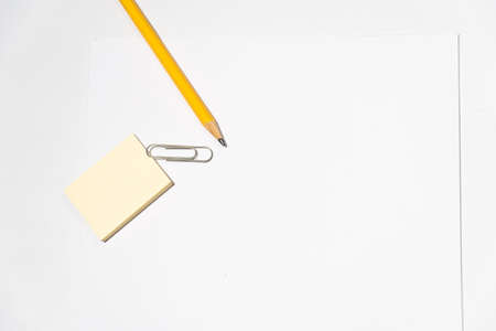 pencil, sticky notes and paper hook on a tableの写真素材