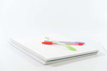 colored pens on a blank notebookの写真素材