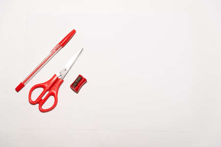 red school equipment on a white tableの写真素材