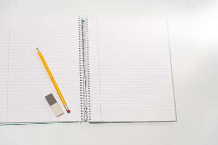 school equipment on blank notebookの写真素材