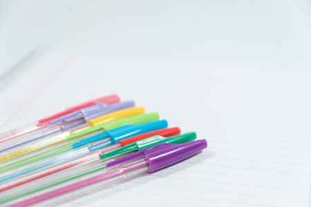 pens of different colors on a blank sheetの写真素材