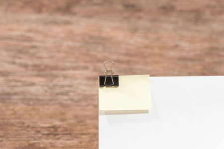 paper hook pinned to a sheet on a wooden table