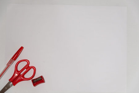 red school equipment on a white tableの写真素材