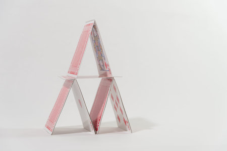 cards placed in the form of a pyramid on a white table
