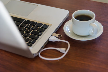 laptop and coffee cup on a wooden table