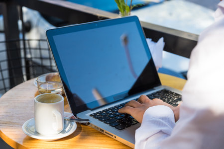 man outdoors working on his laptopの写真素材