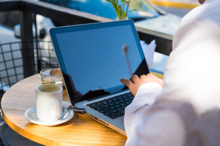 man outdoors working on his laptopの写真素材