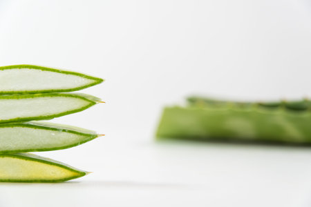 pieces of Aloe Vera and leaves on a tableの写真素材