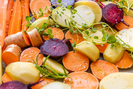Cut raw vegetables, carrots, potatoes, sweet potatoes, beets, kohlrabi, rosemary, garlic, hyssop