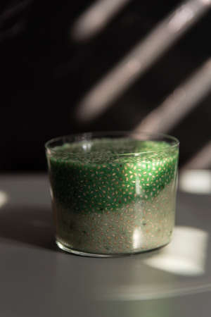 Atmosphere photography of white chia seed pudding with spirulina. Artistic Low key high quality photoの写真素材