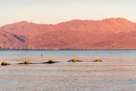 Sunset over the Red sea with pink orange mountains on the background. Eilat, Aqaba, Israel, Jordanの写真素材