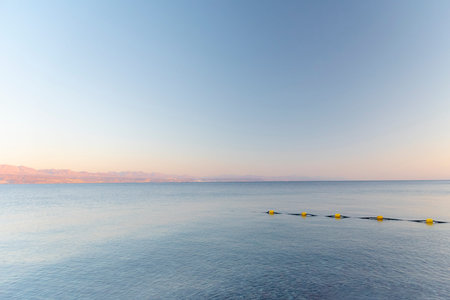 Sunset over the Red sea with pink orange mountains on the background. Eilat, Aqaba, Israel, Jordan