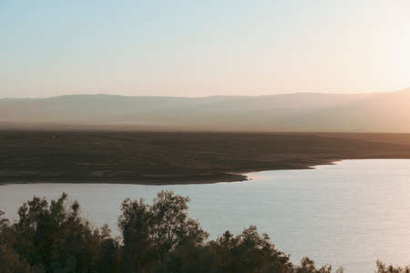 Sunrise over the Dead Sea on a foggy day. A view from Israel To Jordan Mountains.の写真素材