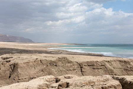 Storm and rain at Dead Sea coastline. Salt crystals at sunset. Texture of Dead sea. Salty seashoreの写真素材