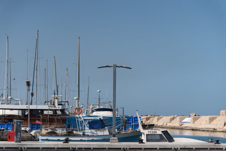 JAFFA ISRAEL MAY 2022: Fishing boats over the Mediterranean sea at the old Jaffo marina. the ancient...