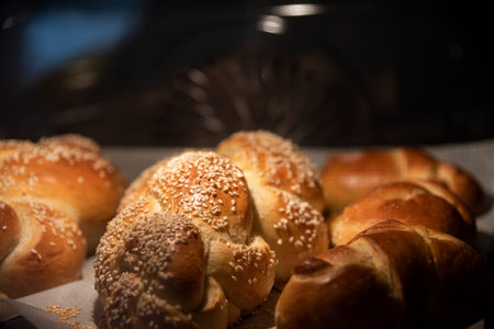 Baking homemade challah bread. Braid challah with sesame seeds on a baking sheet in the oven