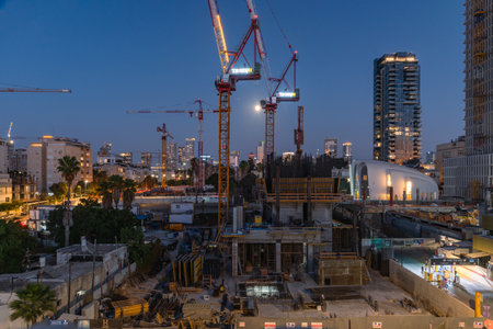 TEL AVIV, ISRAEL - MAY 01 2022: Somail complex in Tel Aviv in the evening with the moon rising. Construction work on the new Tel Aviv Municipality building. Ibn Gvirol Urban Renewalsのeditorial素材