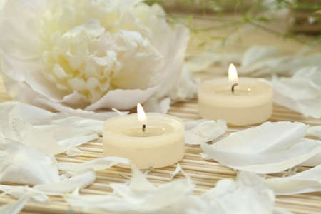 spa candles with peony petalsの写真素材