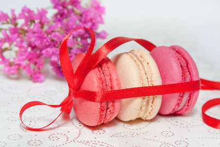 pink macaroons with red ribbonsの写真素材
