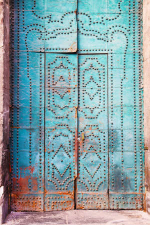 Ancient wooden door with decorative elements and rivetsの写真素材