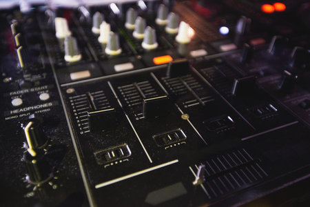 DJ console for mixing music. Close up. Professional music equipment. Technique and modern technologies. DJ job. Nightlife concept. Rave at the party with good music.の写真素材