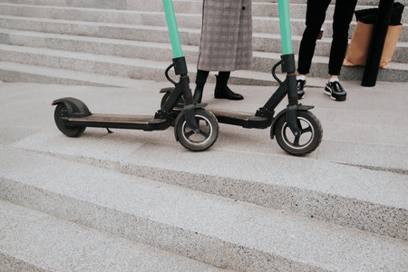 Couple have a good time together riding electric scooters around city. Eco-friendly transport...