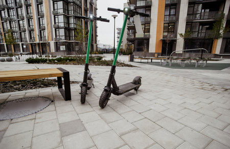 Two green electric scooters. Comfort way to trip around the city. Fast trip concept. Electric scooters for public share standing outside. Eco-transport concept.の写真素材