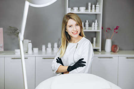 Consultation in cosmetology clinic. Female beauty doctor with black gloves on her hands. Healthcare concept.の写真素材