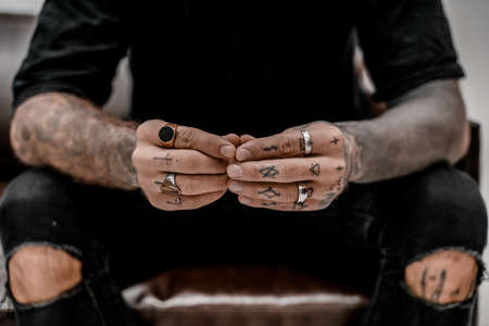 Close up of professional tattooer artist. Tattoo art on body. Equipment for making tattoo art. Master makes tattooed in studio.の写真素材