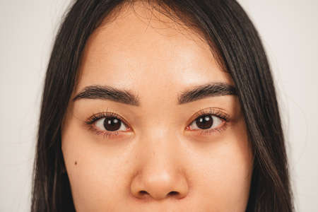 Close up photo of natural woman face. Isolated over white background. Natural beauty and healthの写真素材