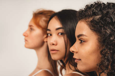 Photo of optimistic young women, face in profile with no make up. Concept natural beauty and girl powerの写真素材