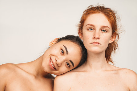 Photo of natural multiracial women. Feminist females stand isolated on white background. Concept...