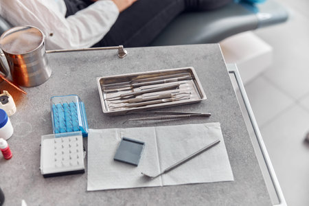 Dental instruments close up. The dentist wears blue gloves. Dental treatment