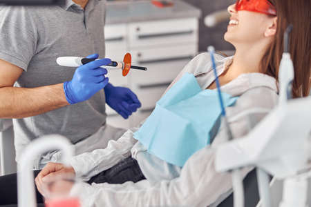 Teeth whitening for woman. Bleaching of the teeth at modern dentist clinicの写真素材