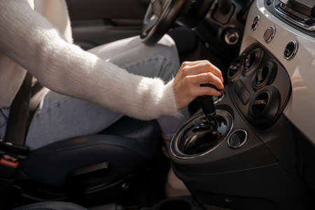 Woman hand shifting gears on gearbox in automobileの写真素材
