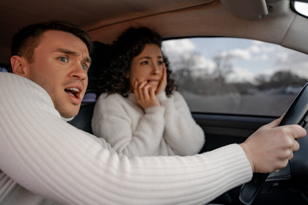 Scared european couple in automobile at accident