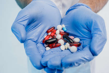 Close up of male doctor hands with medical pillsの写真素材