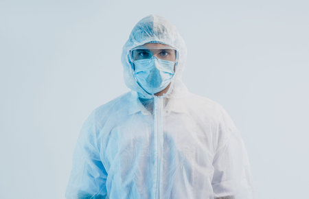 Male doctor wearing white coat and protective mask