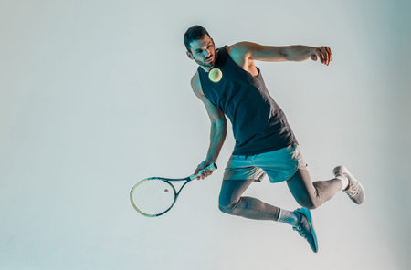 Sportsman hold racquet and hit ball in jump