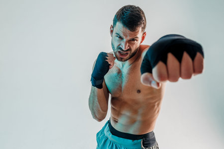 Angry young bearded european boxer is boxing