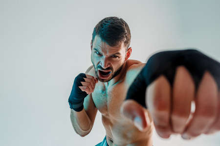 Aggressive young bearded european boxer is boxingの写真素材