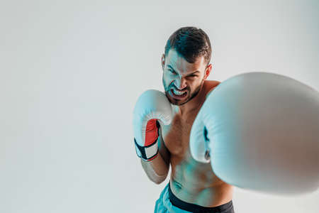 Angry young bearded european boxer is boxingの写真素材