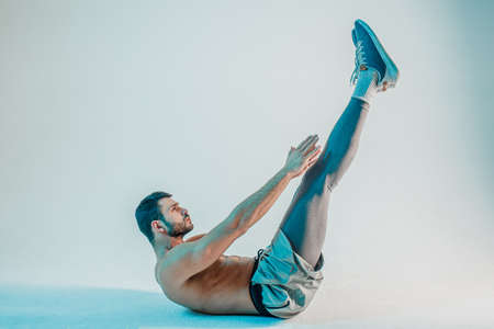 Young bearded european sportsman doing push upsの写真素材