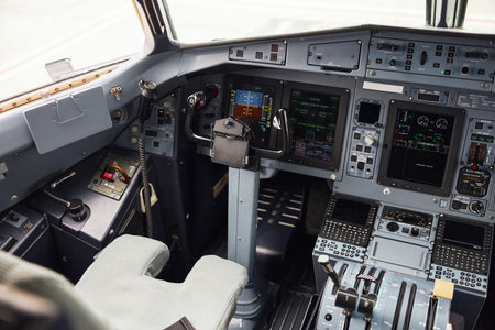 Pilot cabin in modern passenger airplane jet. Captain seat. Empty interior. Dashboard, air...
