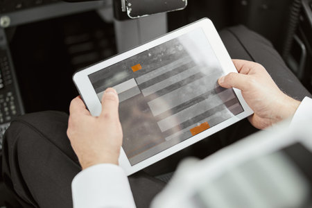 Pilot use digital tablet in passenger airplane jet