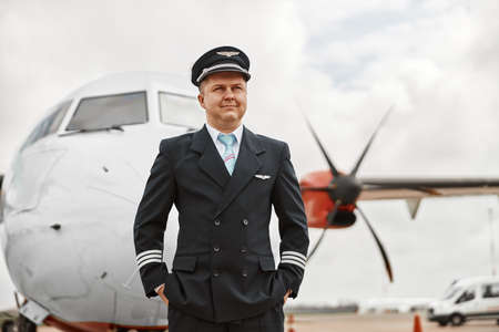Pilot stand on runway on airplane jet backgroundの写真素材