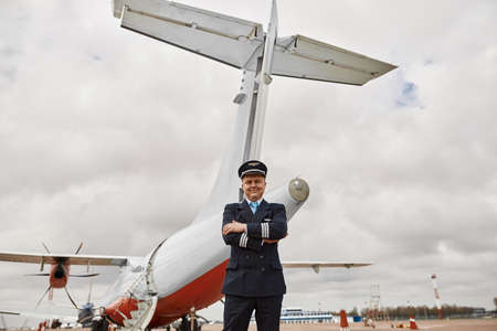 Pilot stand on runway on airplane jet backgroundの写真素材