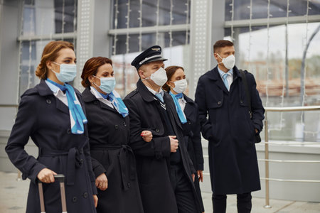 Plane team standing together in modern airport