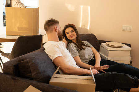 Couple sitting and resting on sofa at home